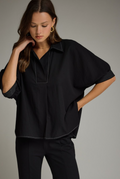Solid short sleeve top featuring split V-neck collar
