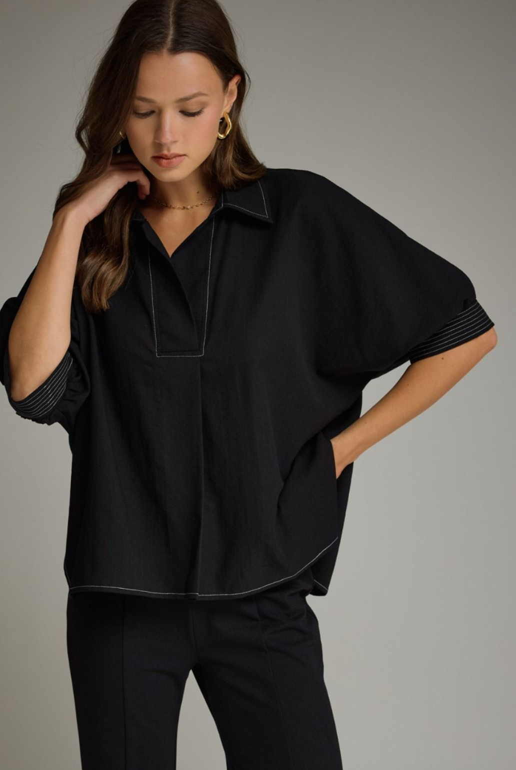 Solid short sleeve top featuring split V-neck collar