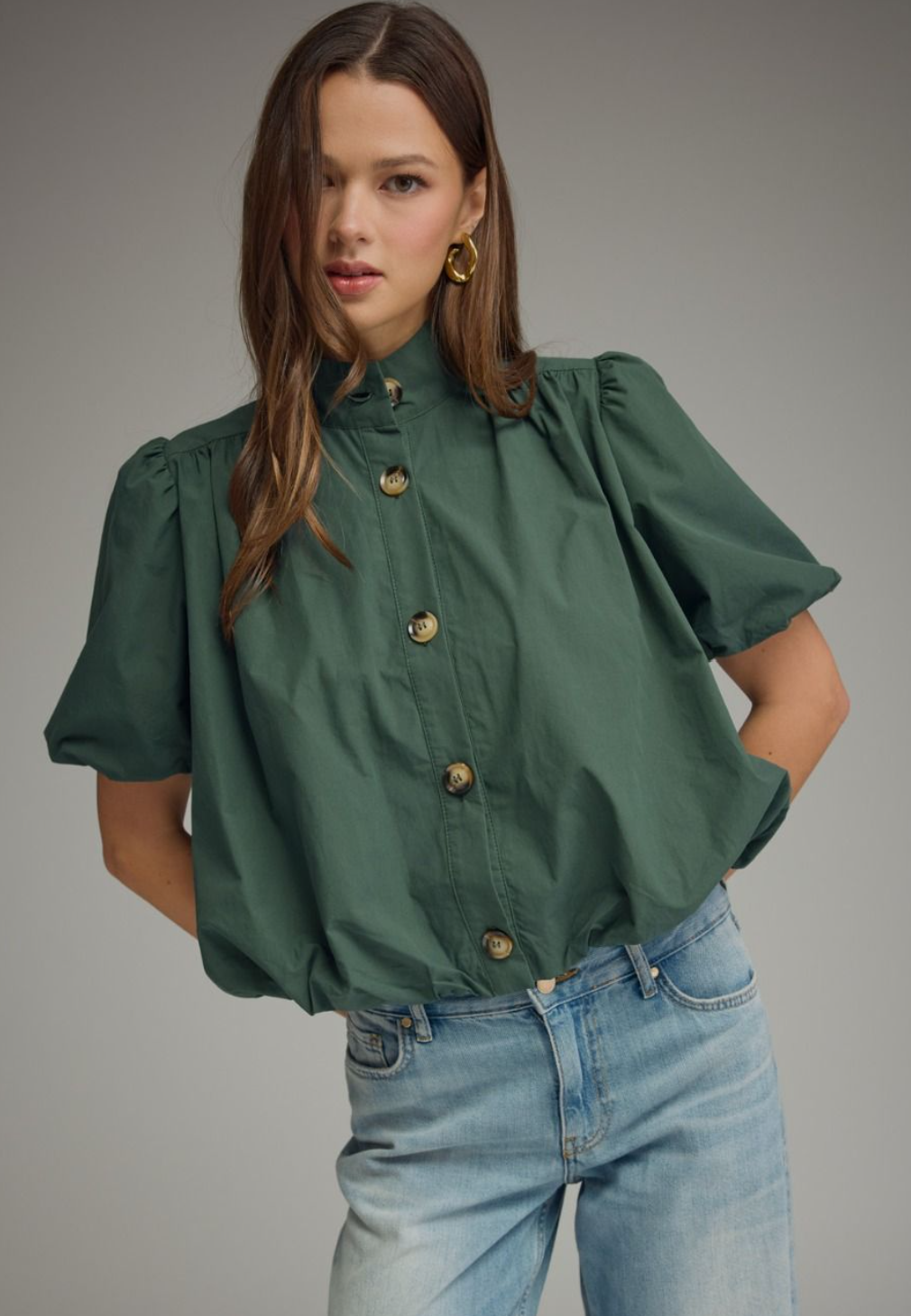 dark green short-sleeve blouse with puff sleeves and gold-tone buttons